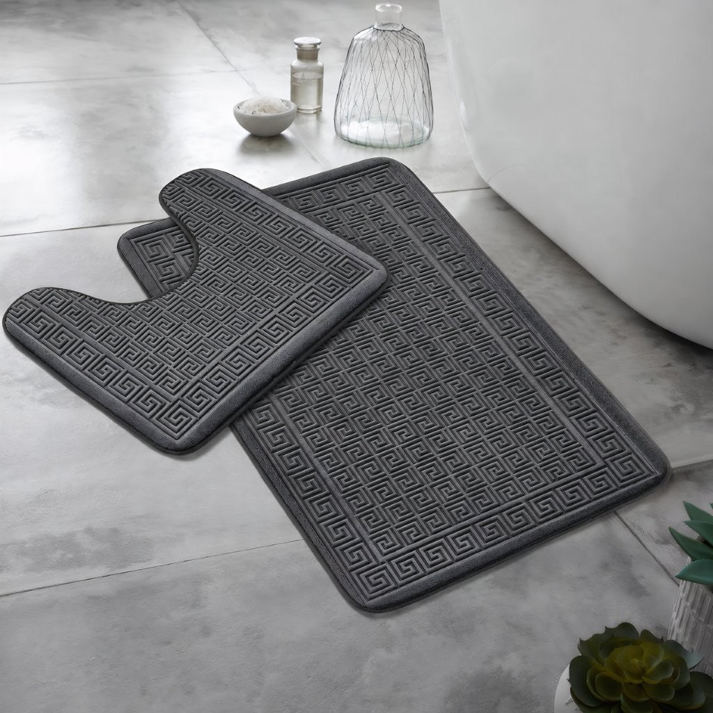 Beige Greek key bath mat set on a tiled bathroom floor