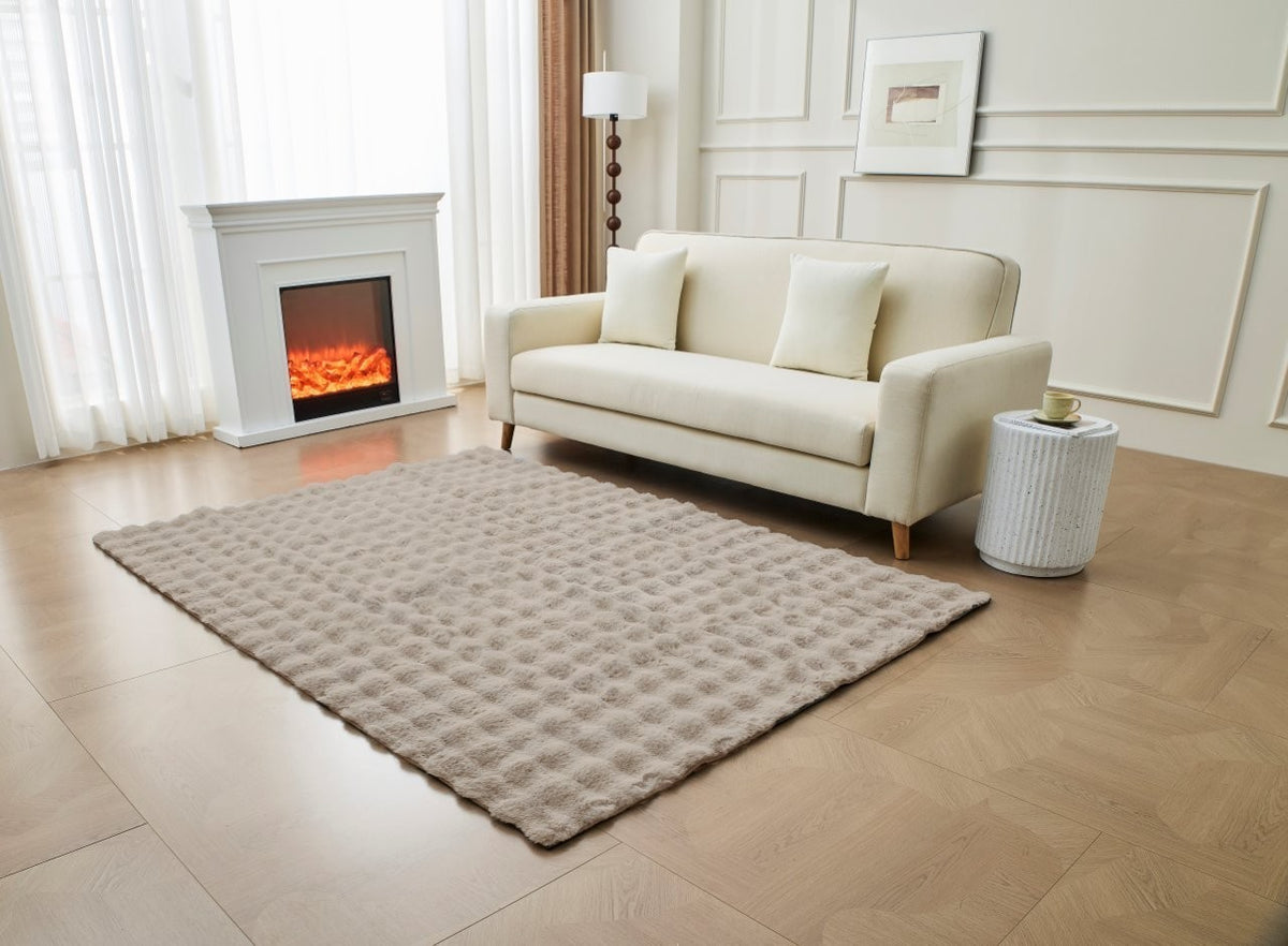 Grey faux fur rug layered on hardwood floor