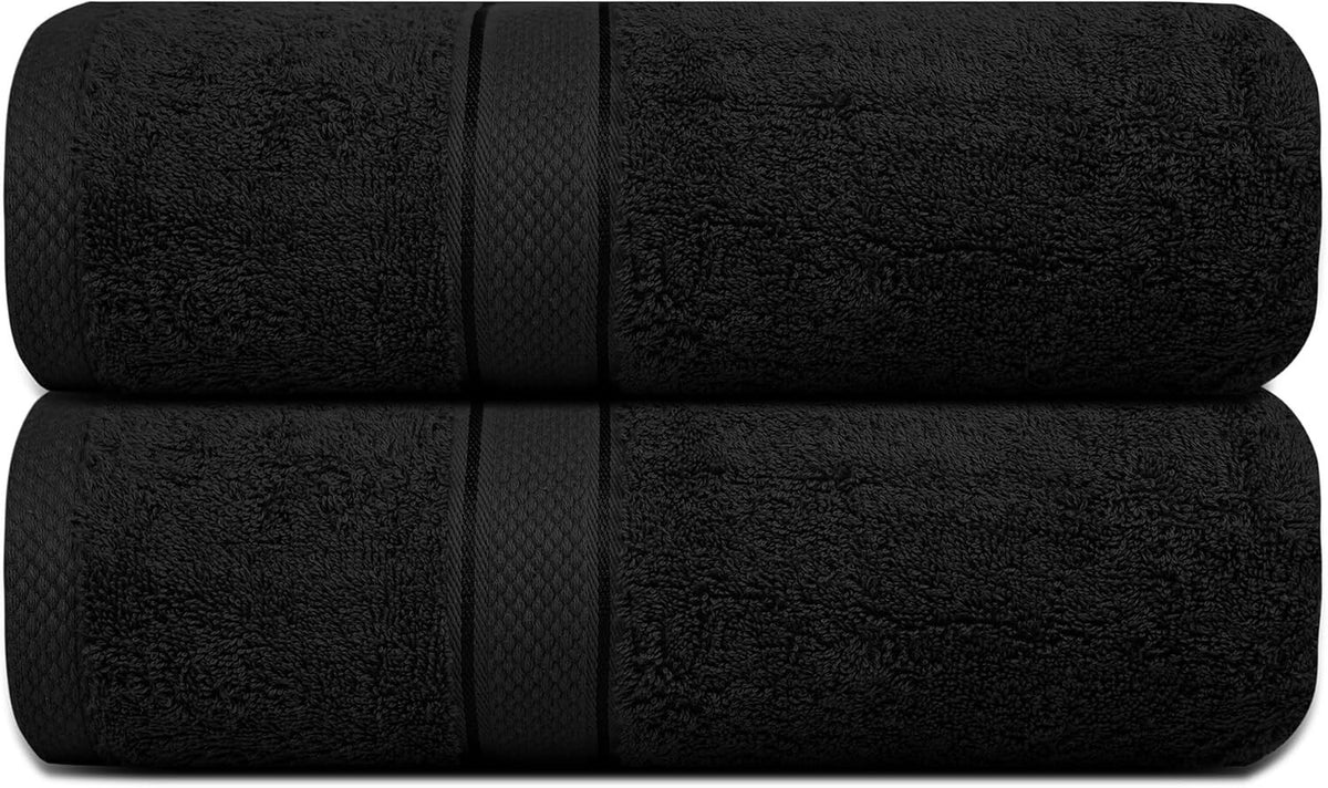 Plush ring spun cotton bath towels folded on a bath tub edge