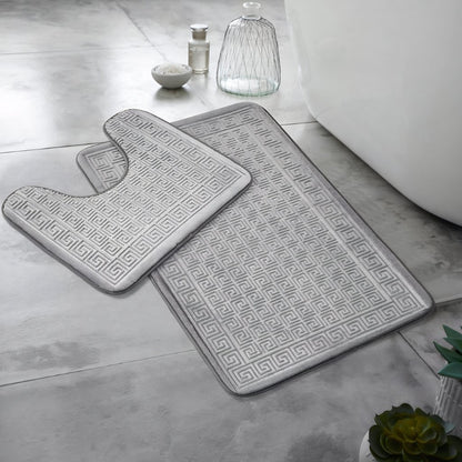 Large Greek key bath mat placed beside a bathtub