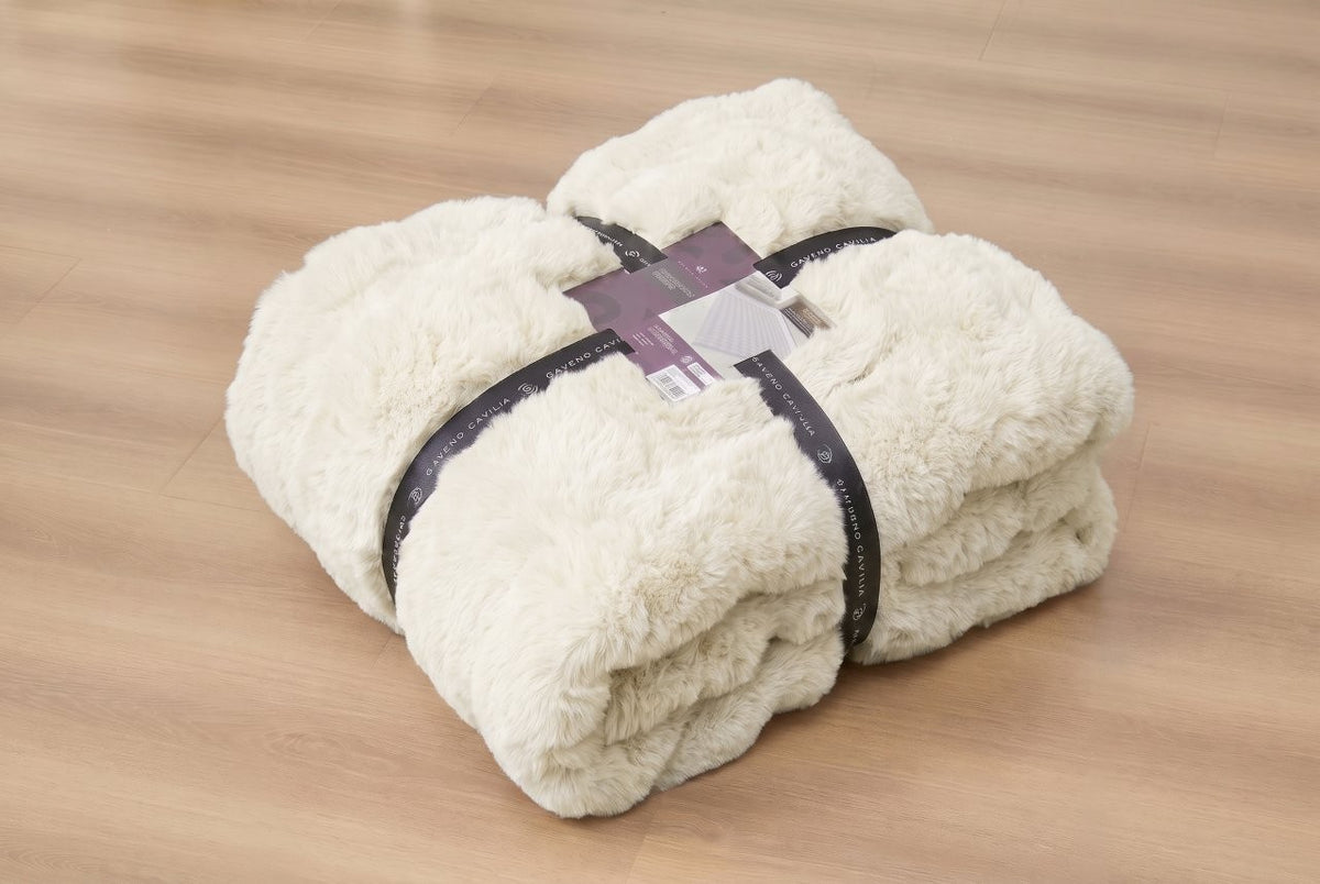 Charcoal faux rabbit fur rug centred on a wooden floor