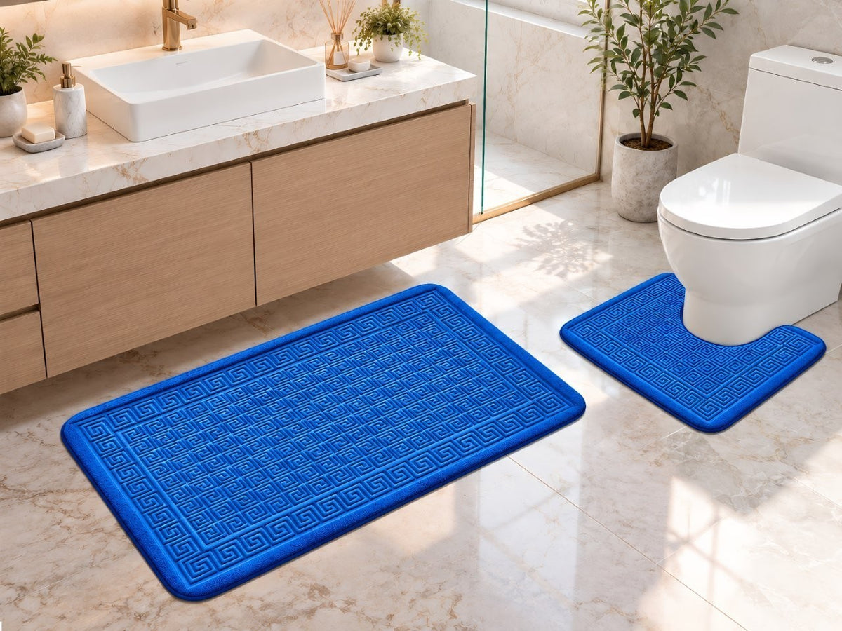 Black and white Greek key bath mats in a monochrome bathroom