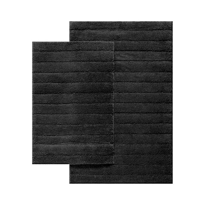 Cleo ultra plush bath mat in front of a bath in a modern bathroom