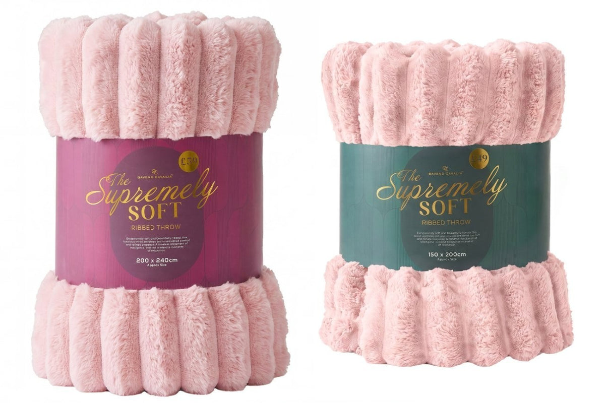 Blush pink chunky fleece throw styled on an armchair