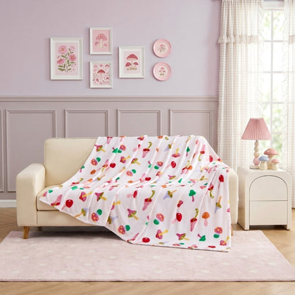 Daisy Green floral print fleece throw on a reading chair