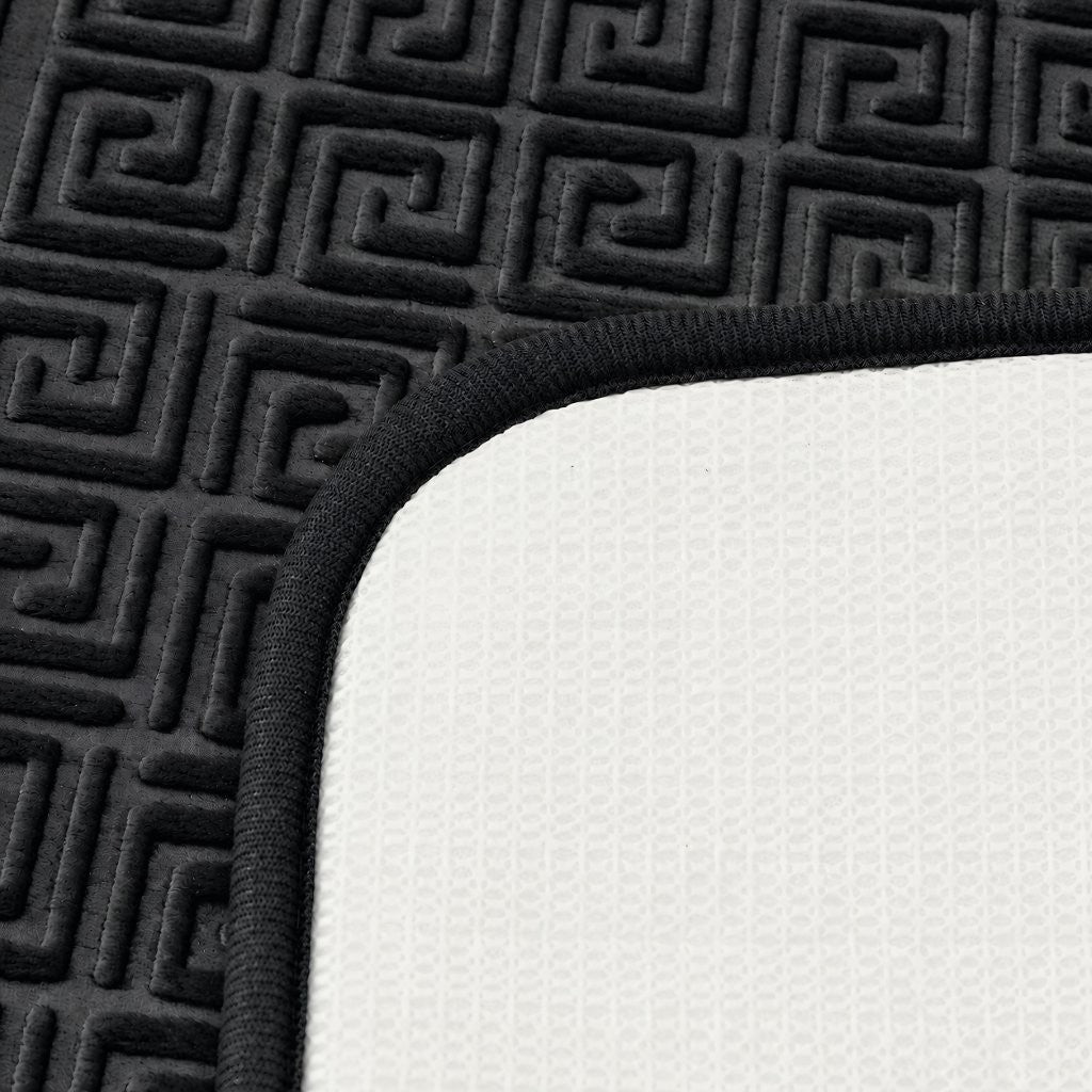 Cream Greek key bath mat set in a bright modern bathroom