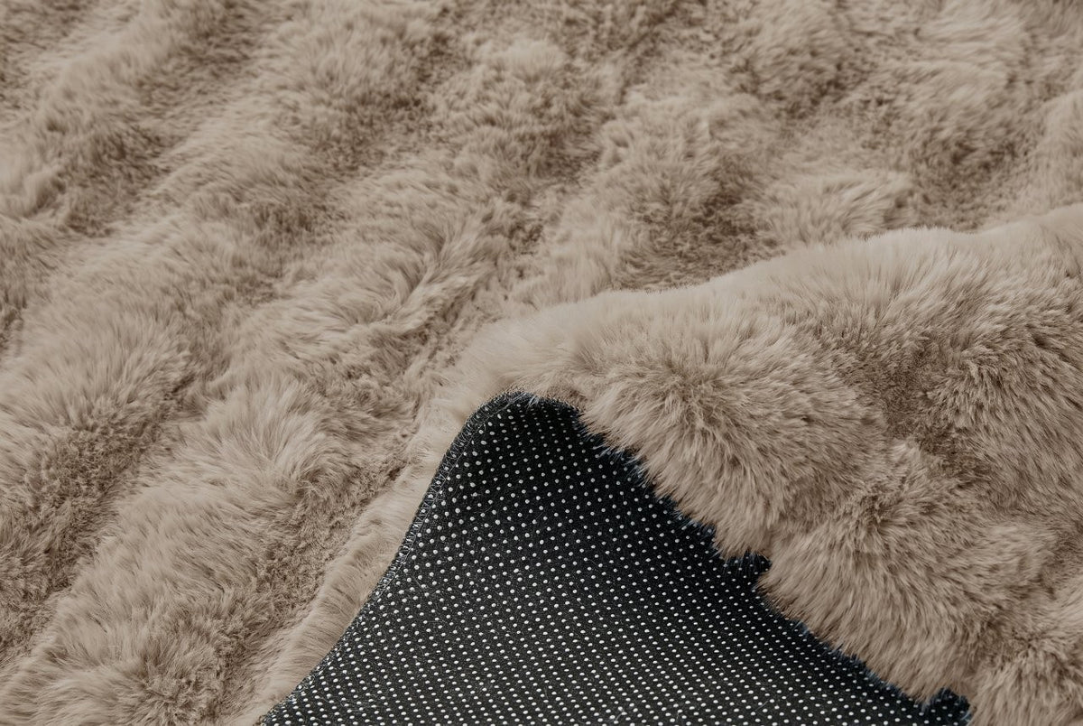 Cream faux fur rug shown in a soft-lit nursery