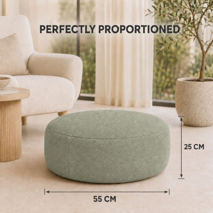 Beige square inflatable ottoman beside a rattan garden set