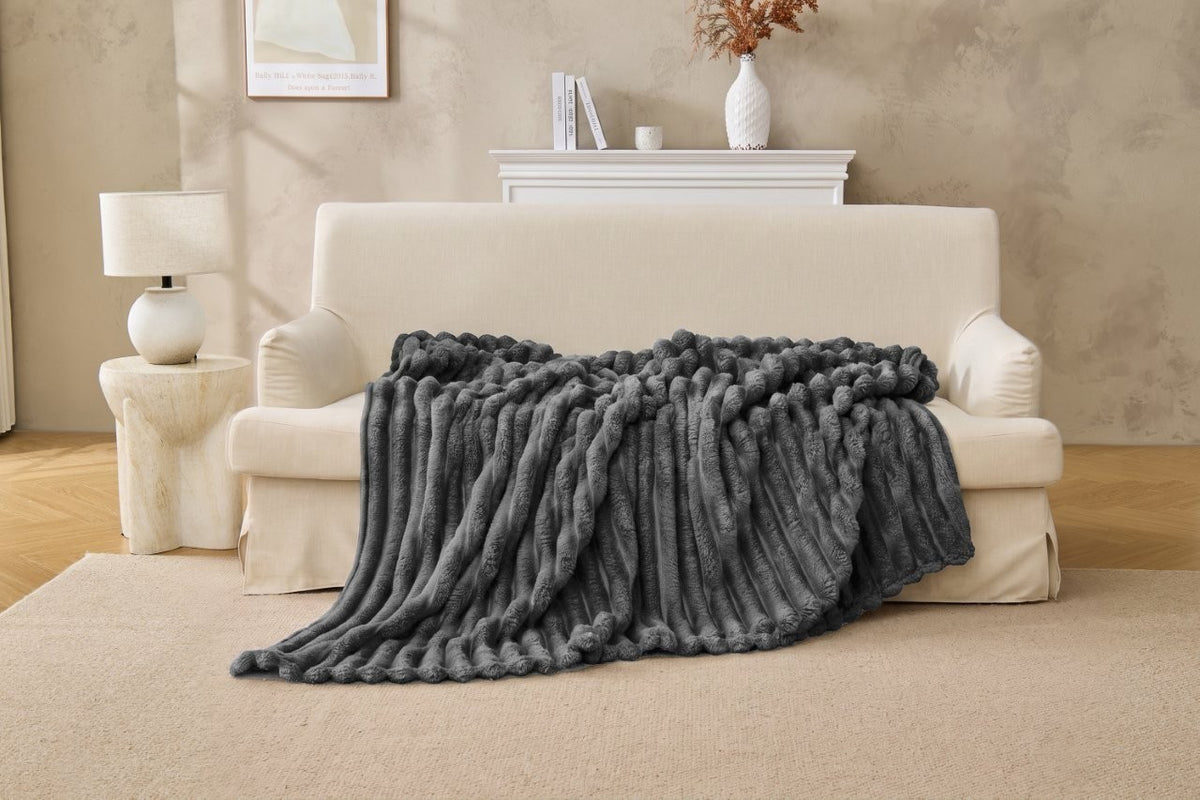 Natural colour ribbed fleece throw in a light neutral bedroom