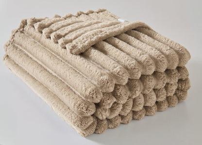 Charcoal chunky throw blanket folded on an armchair