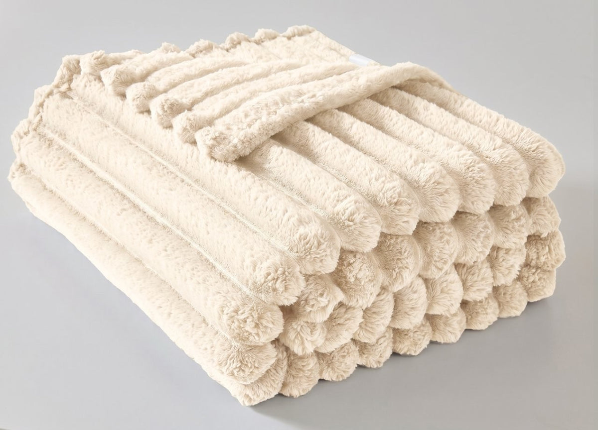 Natural chunky throw blanket draped over a settee