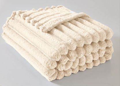 Natural chunky throw blanket draped over a settee