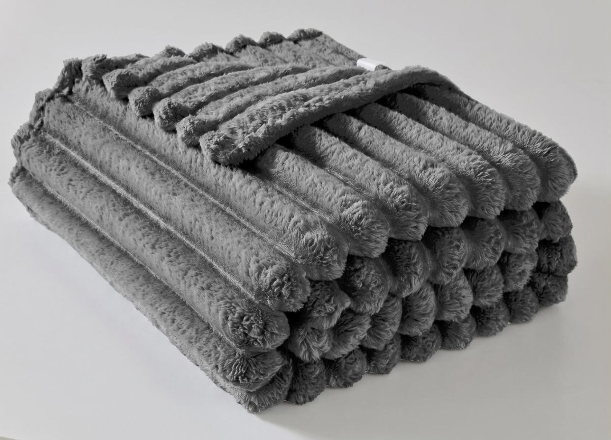 Navy ribbed fleece throw spread across a king size bed