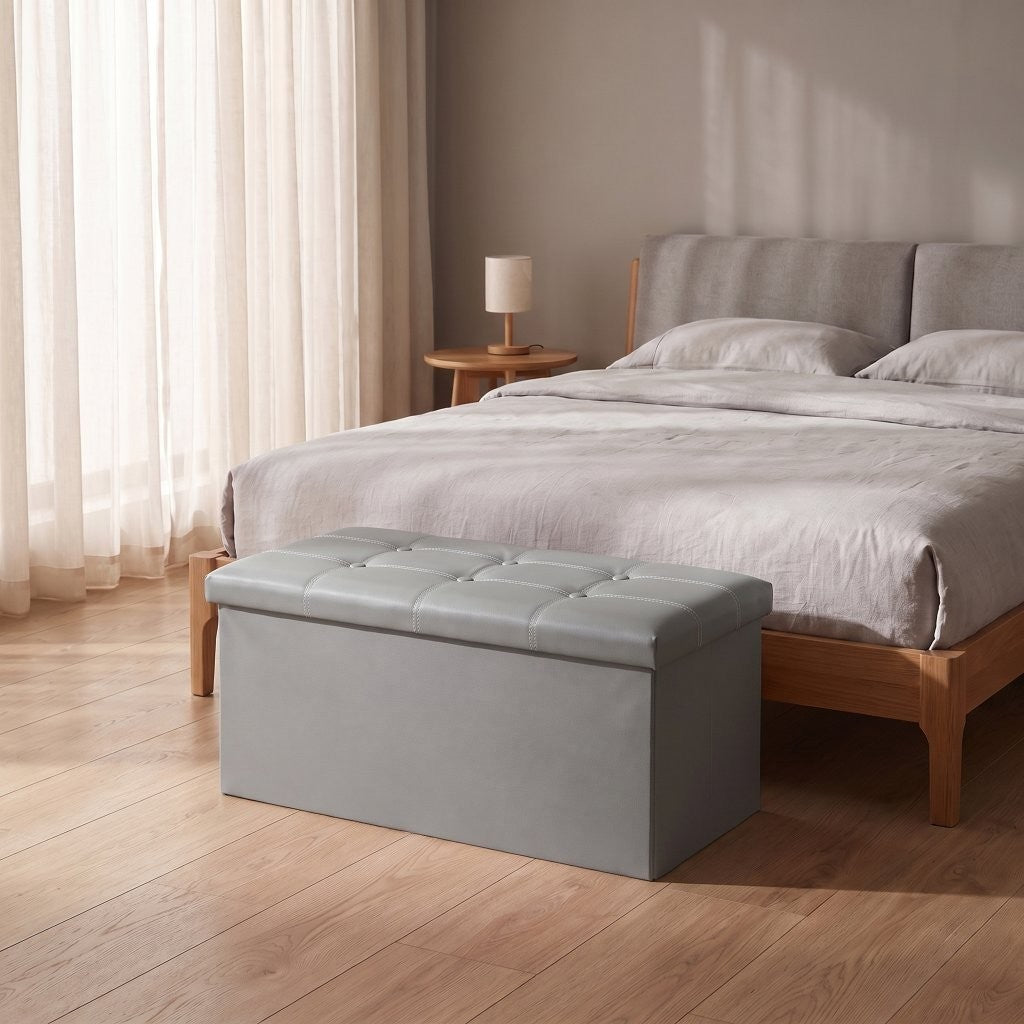 Storage ottoman styled at the end of a bed as a blanket box