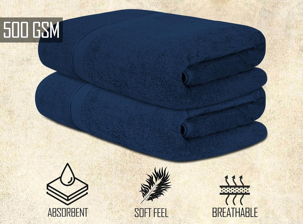Beige and white bath towels layered on a bathroom bench