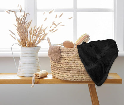 Beige cotton bath towel shown draped over a chair