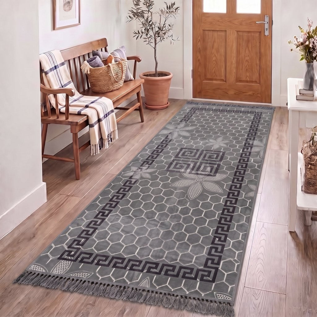 Charcoal Greek key rug on hard flooring under a coffee table