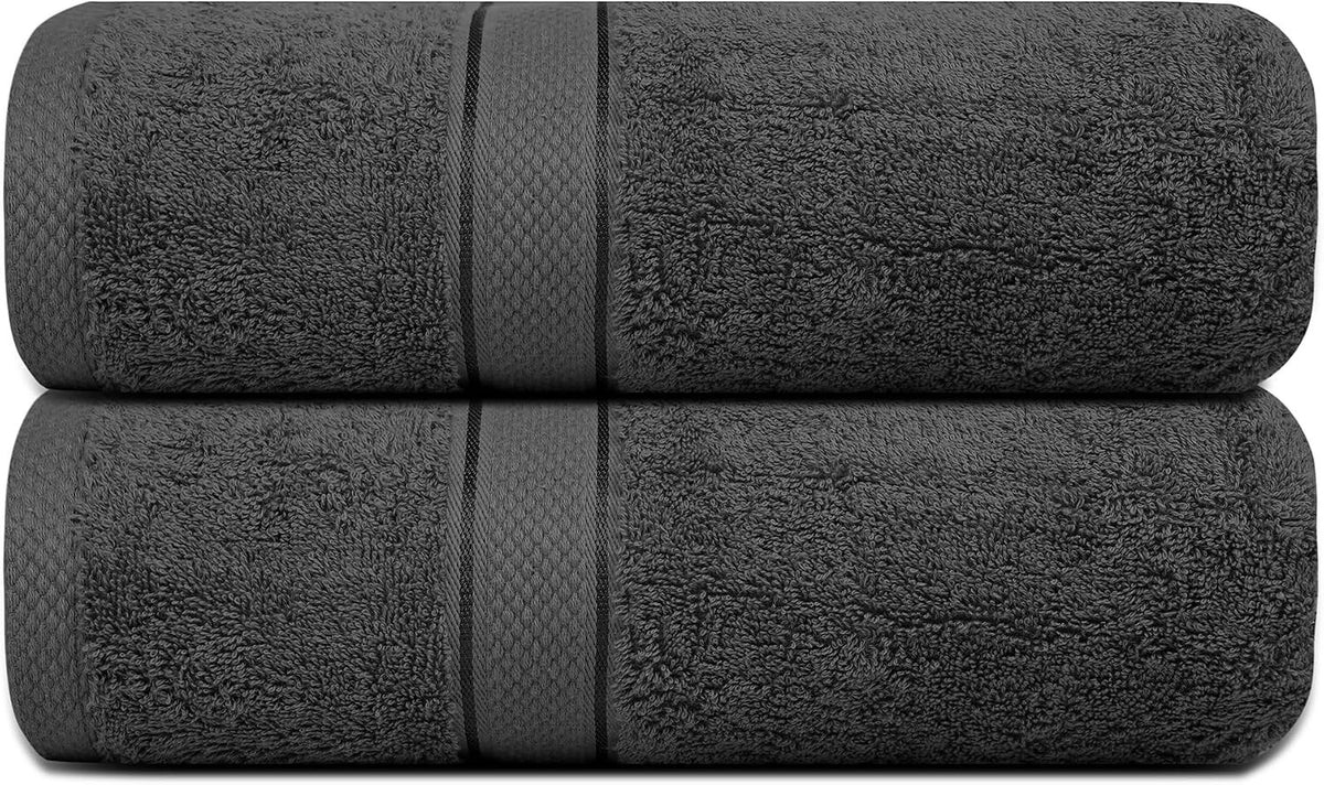 Grey bath towel set neatly folded on a wooden bench