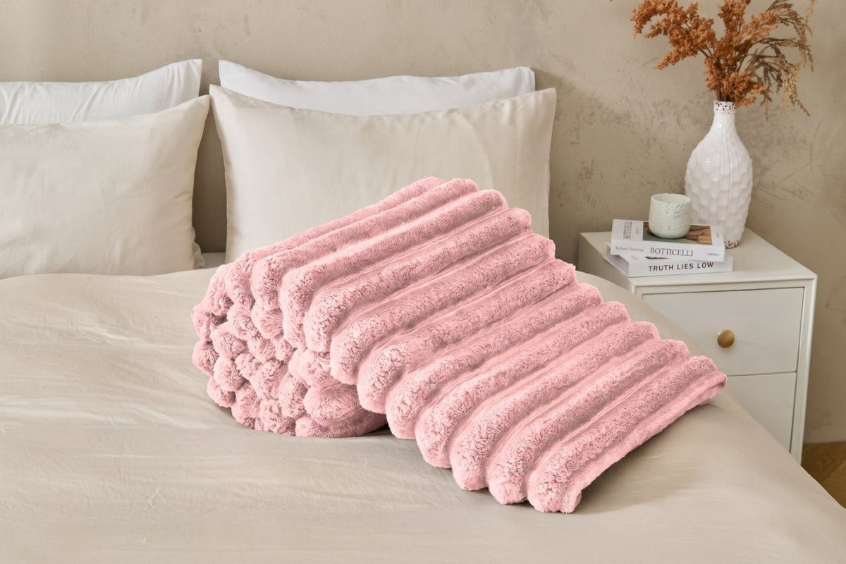 Red ribbed fleece throw blanket adding warmth to a bedroom