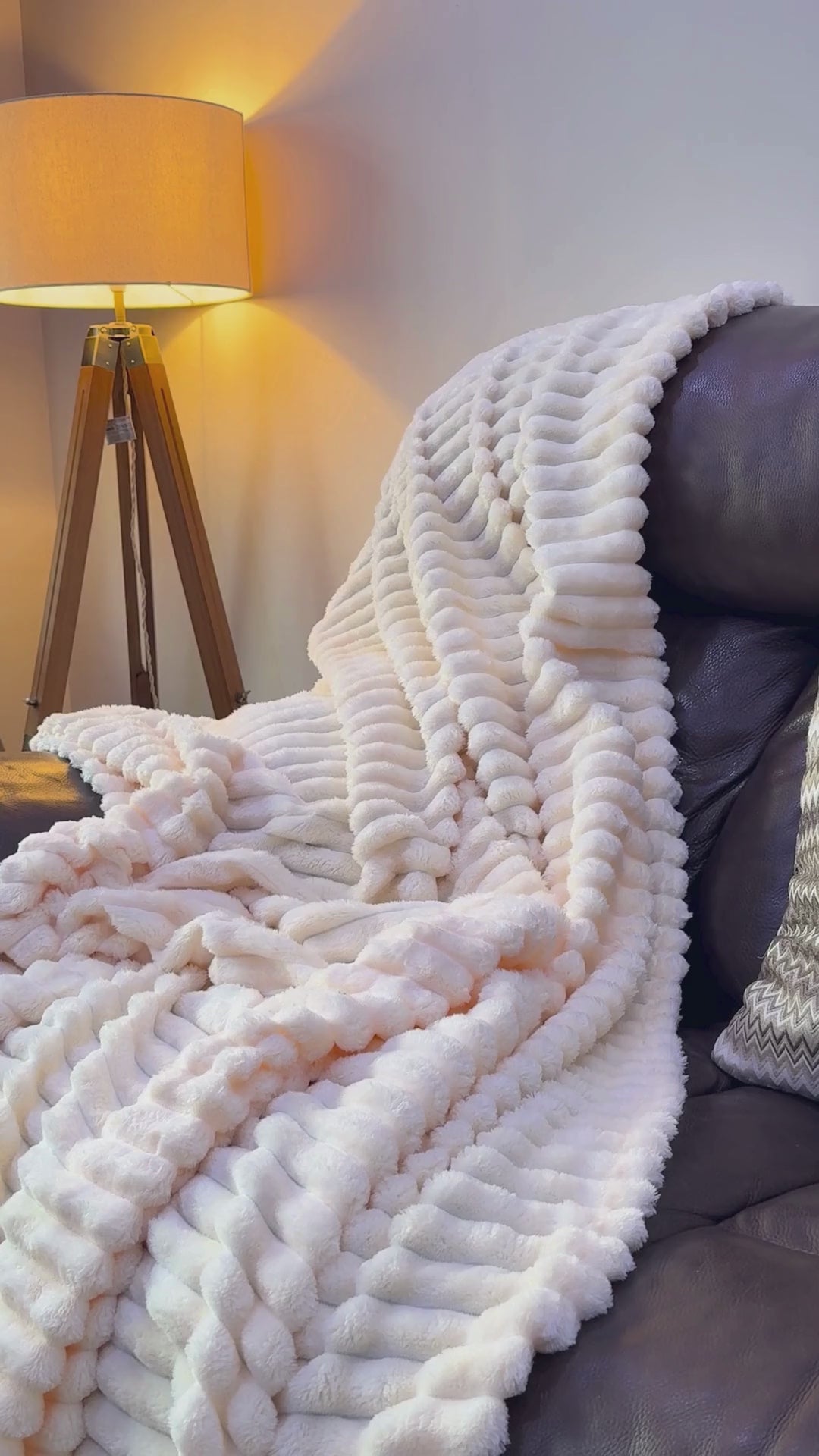 Large ribbed corded throw blanket draped over sofa – chunky cord faux fur fleece in double and king size