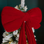 Red velvet Christmas bow close-up - luxury texture detail