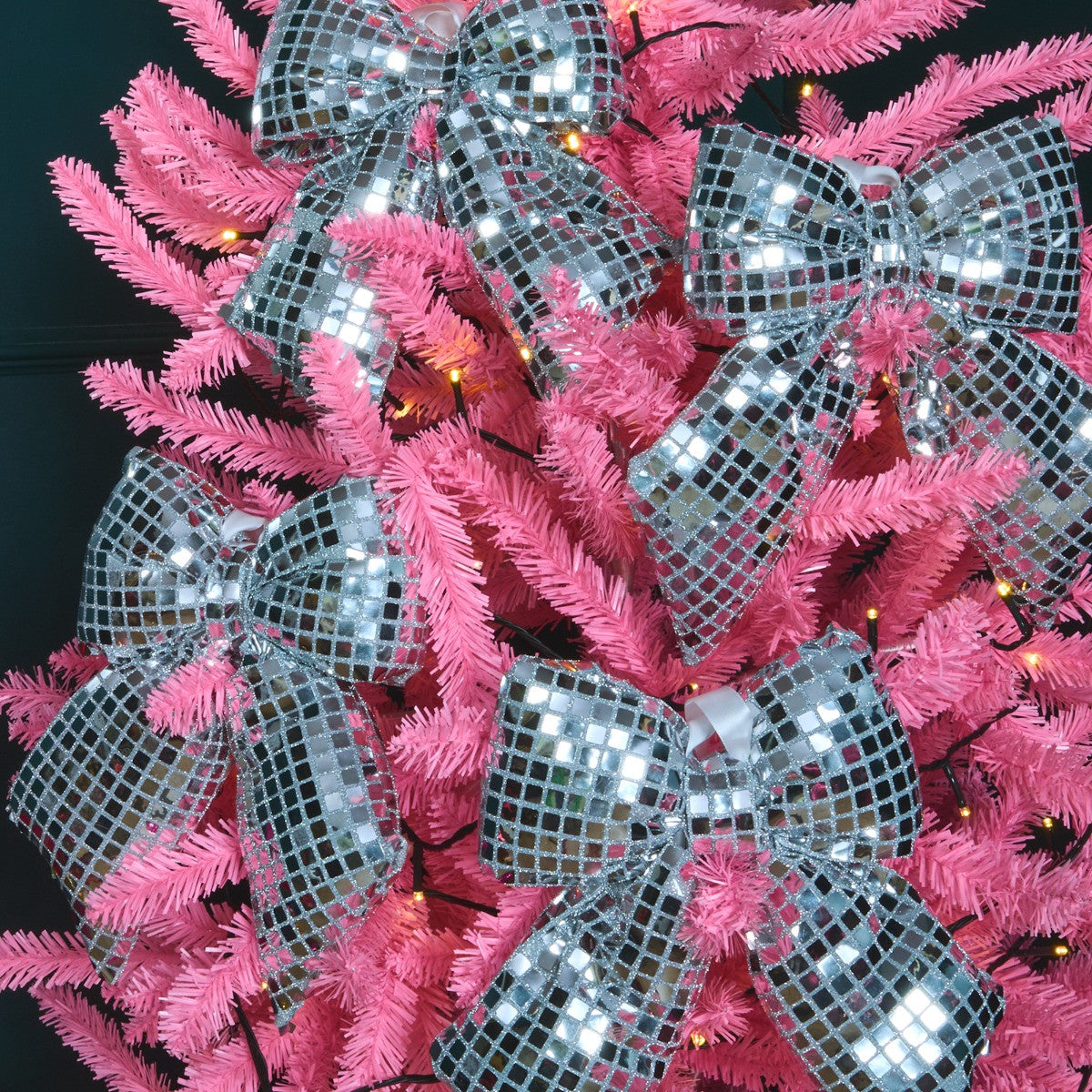 Mirrored silver Christmas bow close-up - disco ball effect ornament