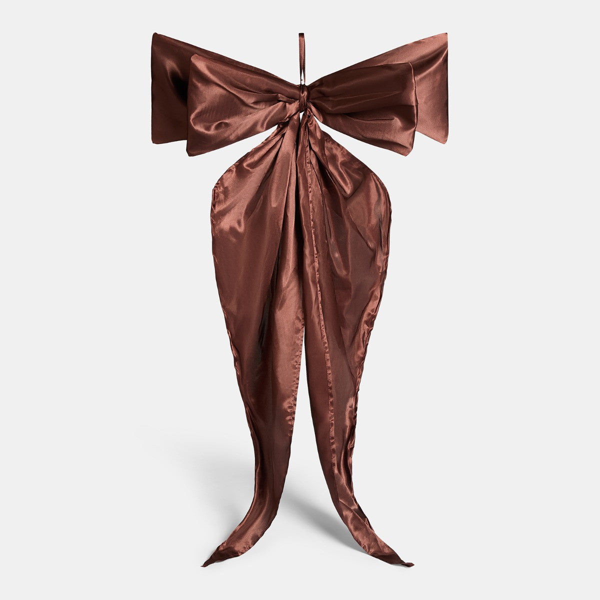 Chocolate Christmas bow close-up showing satin sheen and flowing tails