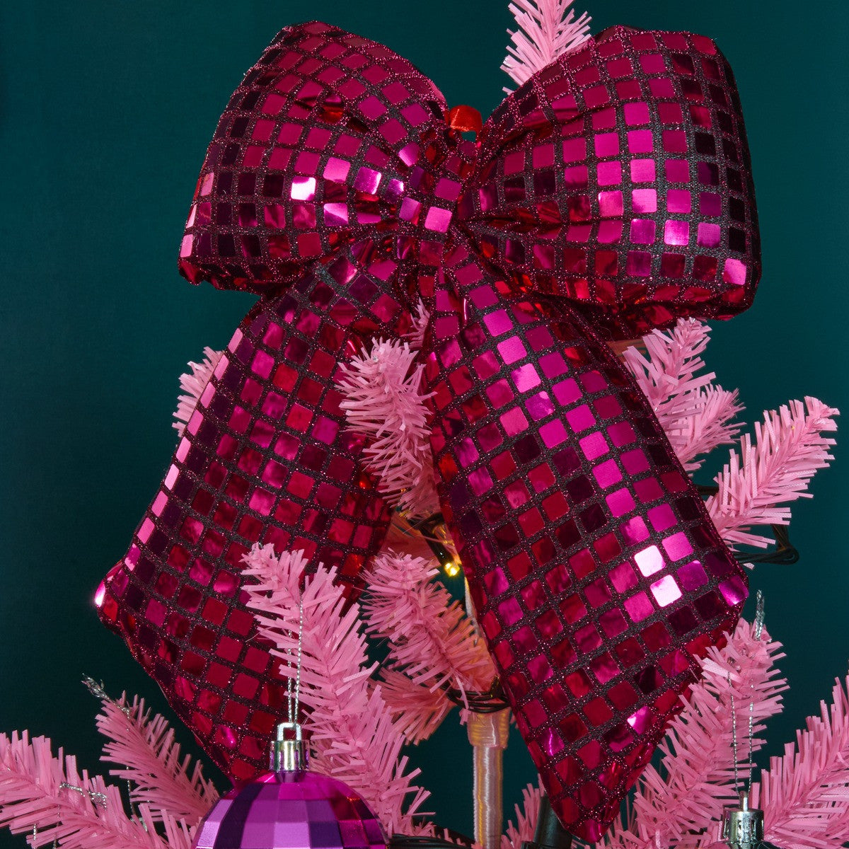 Pink disco ball bow styled on Christmas tree - Barbiecore festive