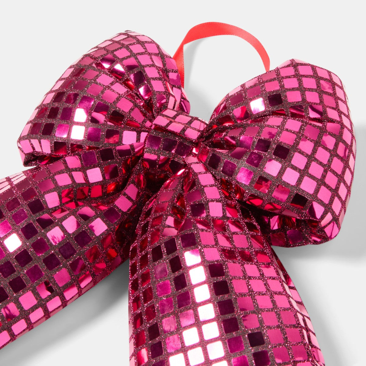 Pink mirrored bow on gift display - Pinkmas party decor