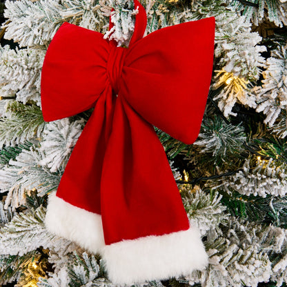 Red Christmas bow styled on tree branch - traditional bows trend