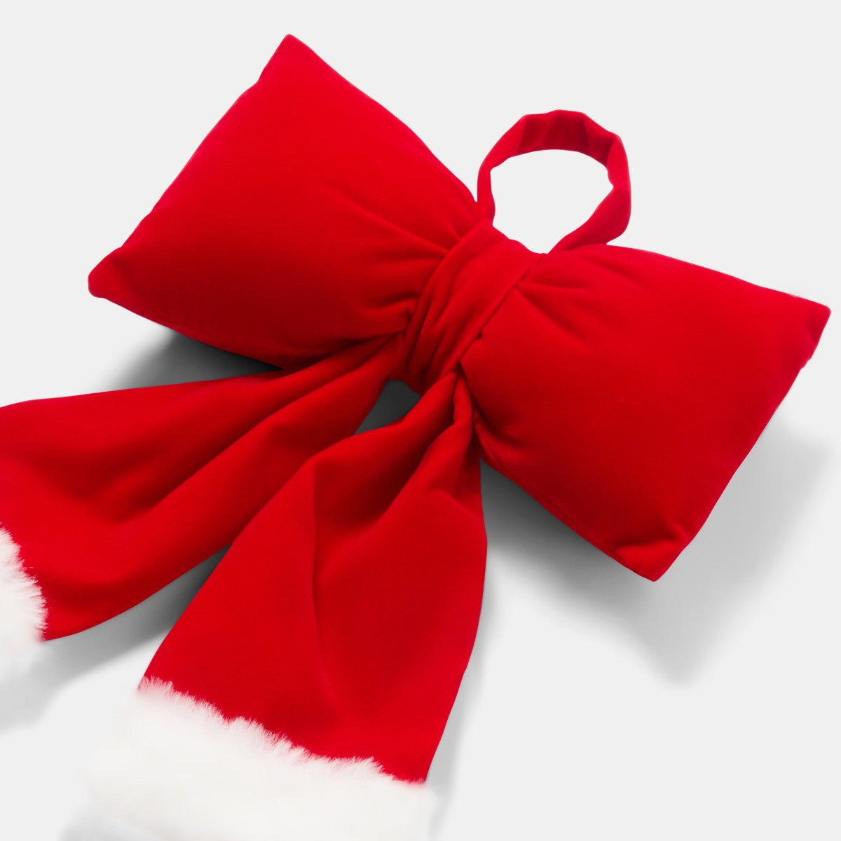 Red Christmas bow on wreath - festive door decoration