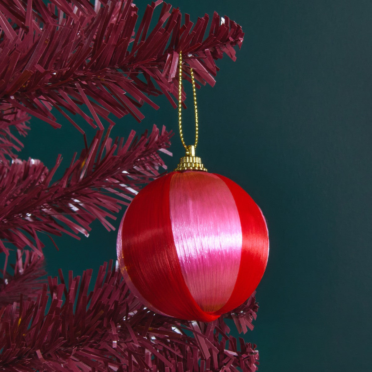 Pink red Christmas baubles styled on tree - Merry Pinkmas festive