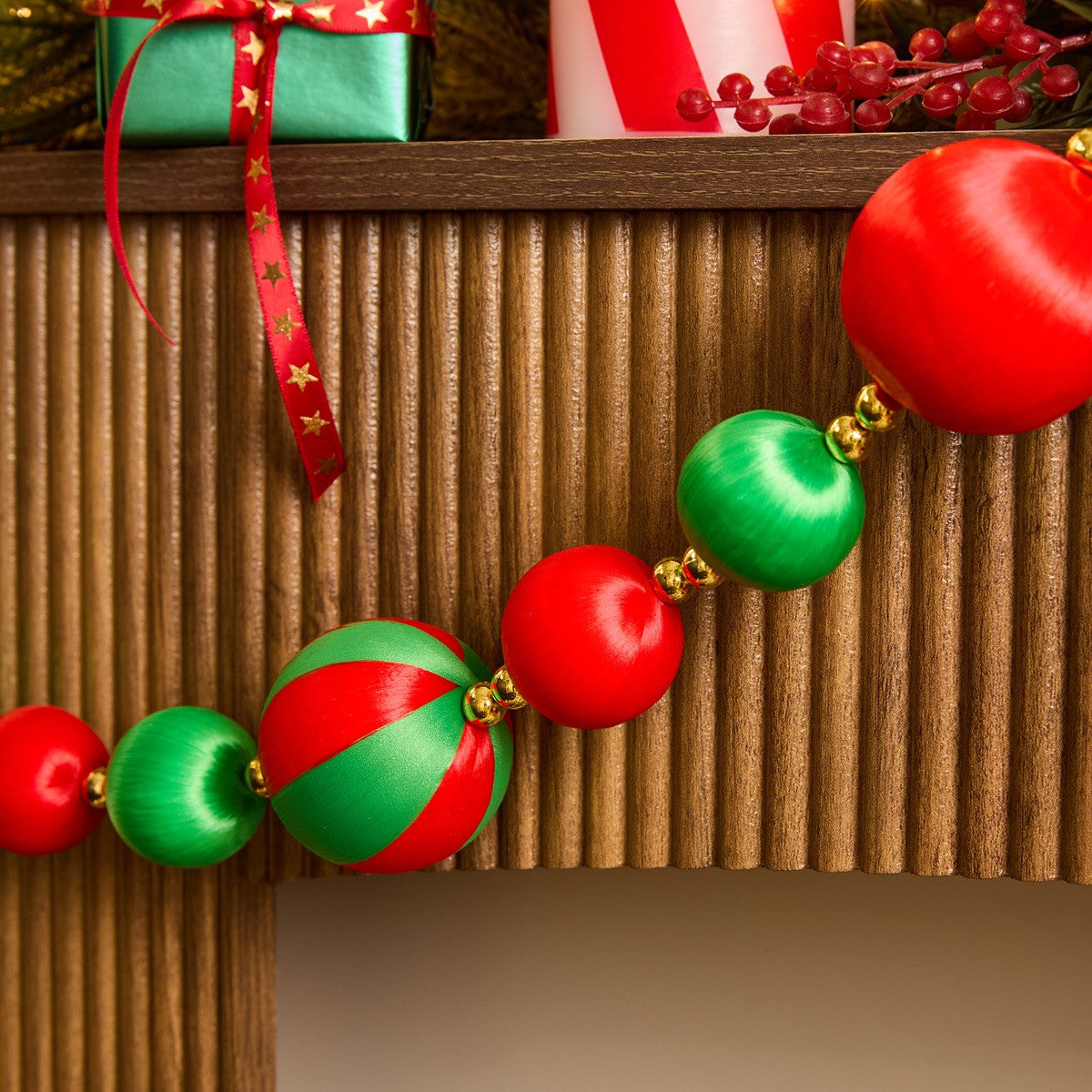 Red green striped Christmas baubles styled on tree - traditional festive