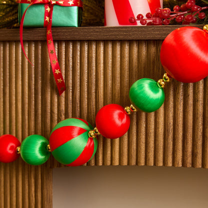 Red green striped Christmas baubles styled on tree - traditional festive