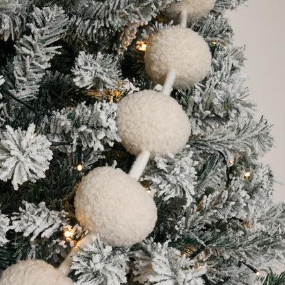 Nordic frost cream pom pom garland styled on Christmas tree