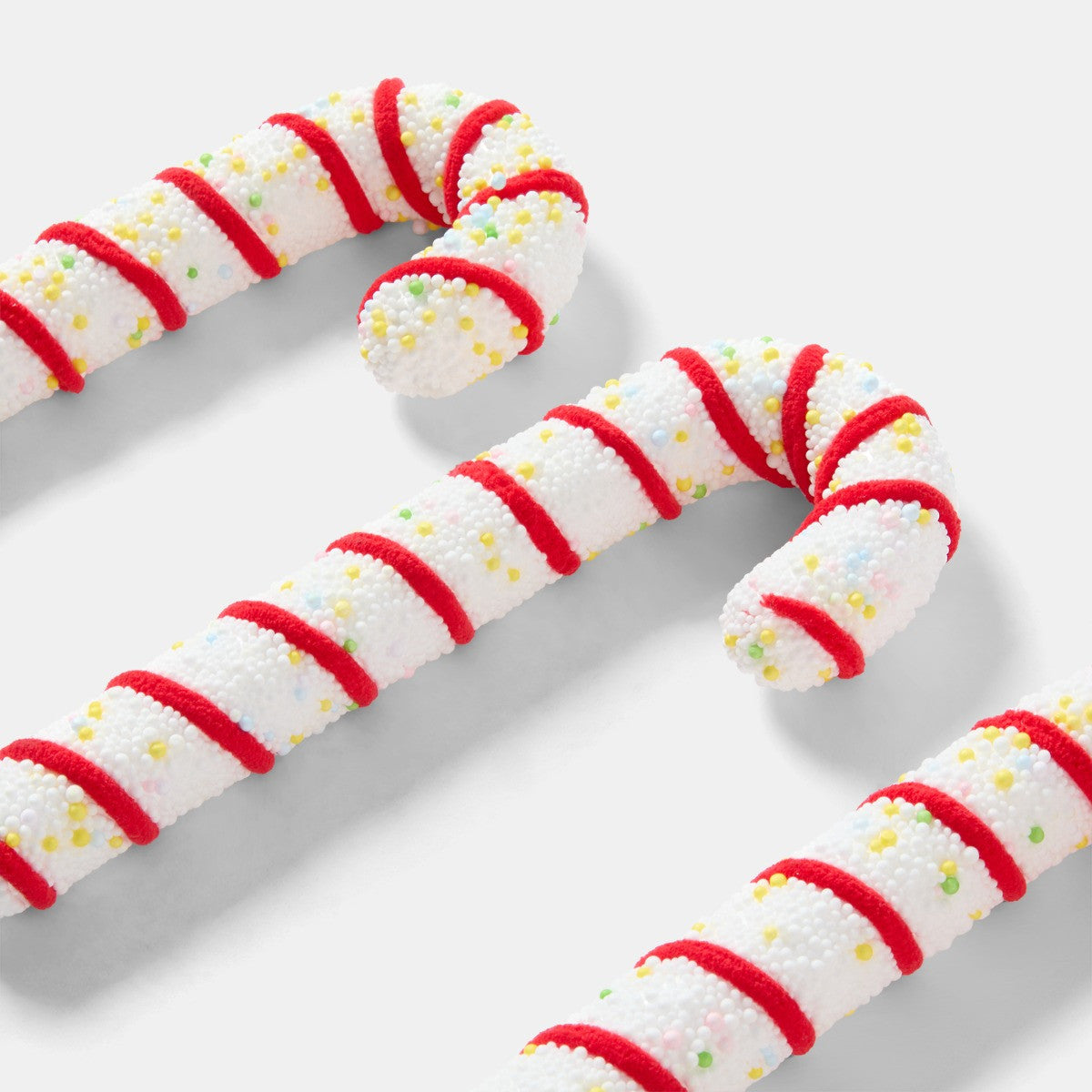 Traditional red candy cane decoration styled on festive display