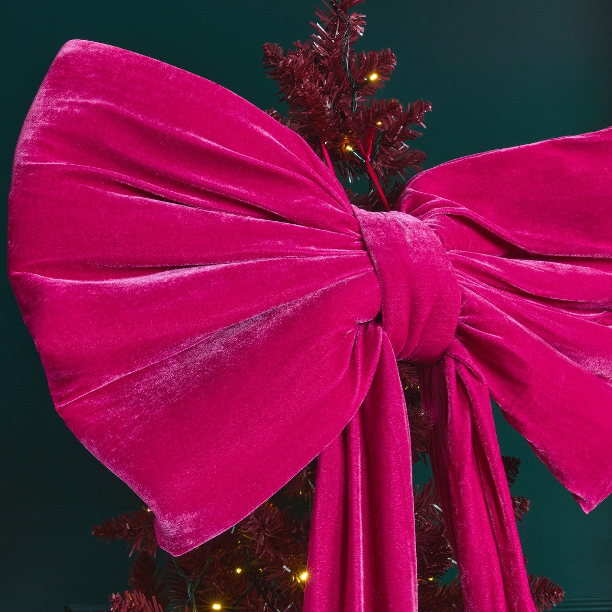 Pink velvet tree bow styled as Christmas tree topper - Barbiecore festive