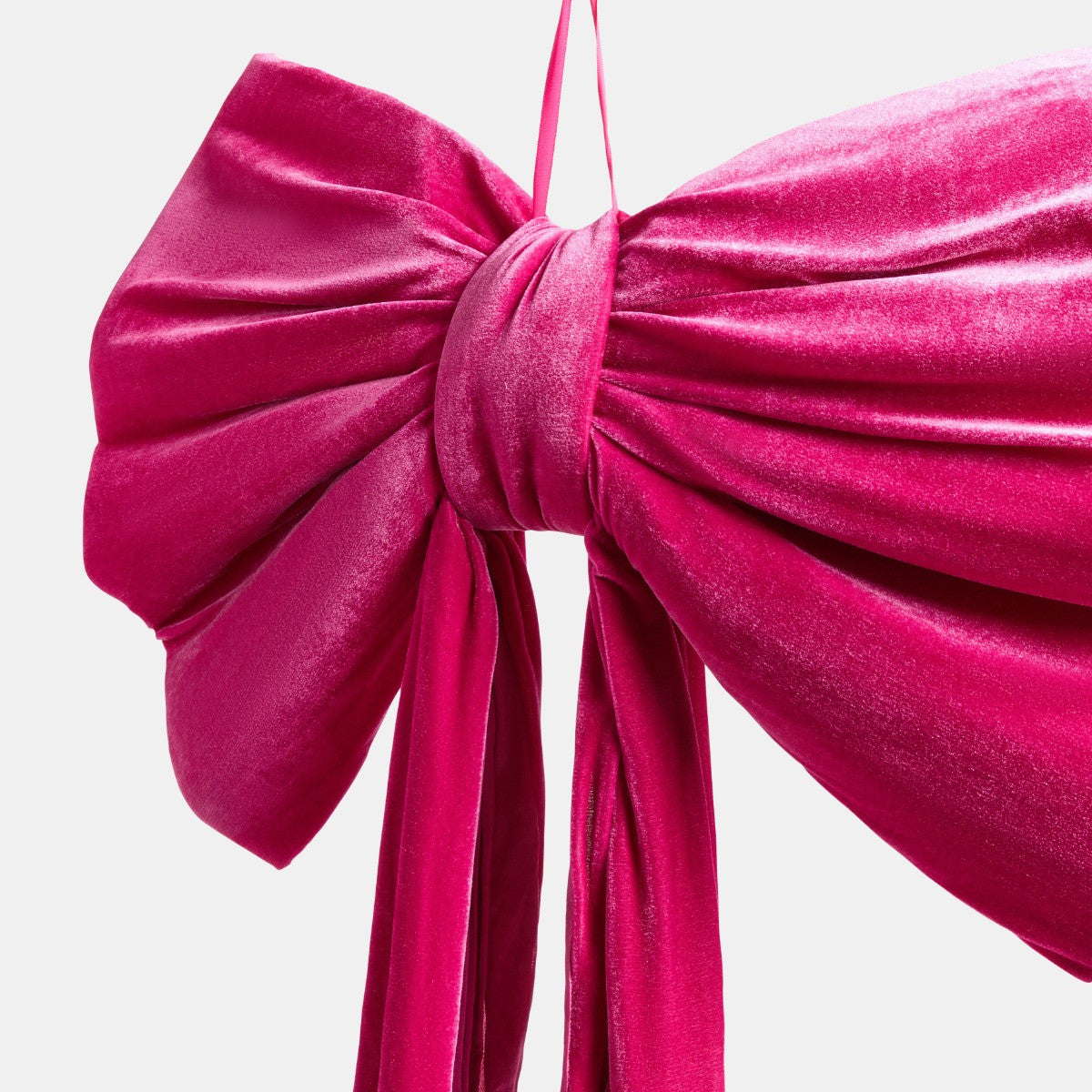 Pink velvet bow draped as Pinkmas Christmas topper - glam styling